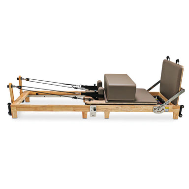 Full Side View of the Impact Fitness Foldable Pilates reformer with brown carriage and oak frame