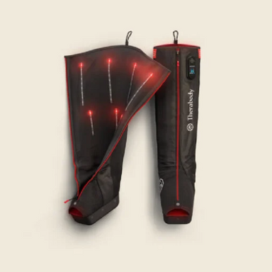 Flatlay on white background of Therabody JetBoots Pro Plus with one boot unzipped to show internals