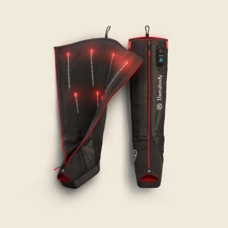 Flatlay on white background of Therabody JetBoots Pro Plus with one boot unzipped to show internals