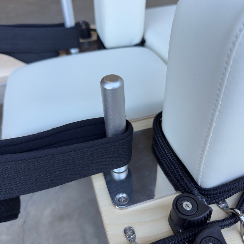 Close up of Straps Looped over hook rods for Milaron Maple Studio Reformer