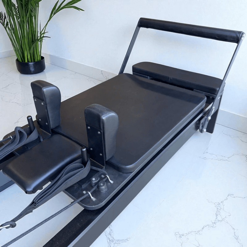Close up angle view of carriage and footbar on Milaron Pearl Reformer Machine