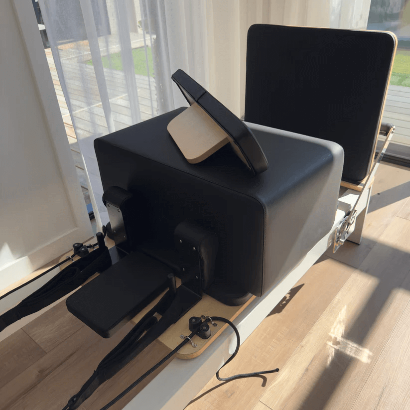 Close up of sitting box on reformer bed carriage and jumpboard attached