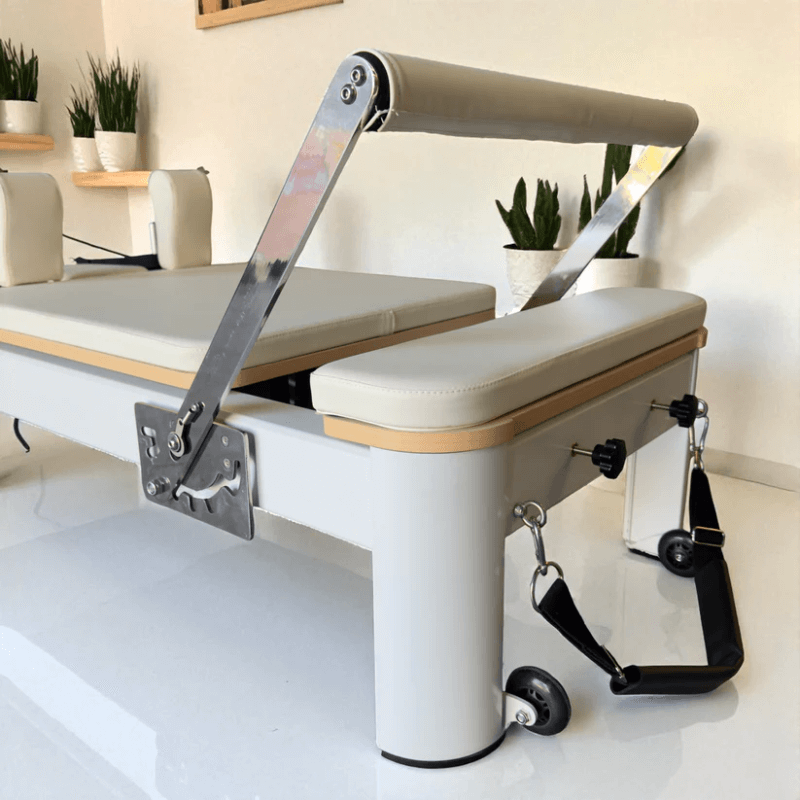 Back close up view of footbar and carriage of Milaron Pearl Reformer in creme
