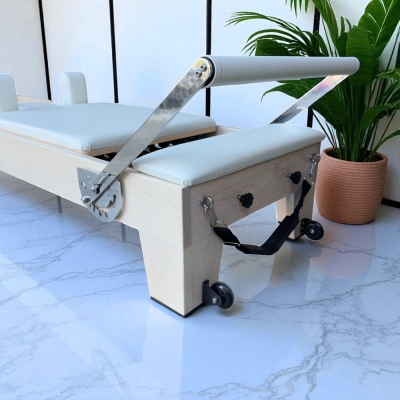 Close up back view of Footbar and Carriage for the Milaron Maple Studio Reformer in Creme