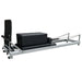 Full Angled Side Image of ABCO Low Pilates Reformer with Aluminium Frame and black carriage with sitting box and jumpboard attached