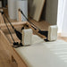 Eco Foldable Pilates reformer machine with wooden frame and white upholstery