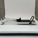 Core Collab Queen 2.0 Pilates reformer machine with white frame and black carriage direct side profile on a light gray photo shoot background