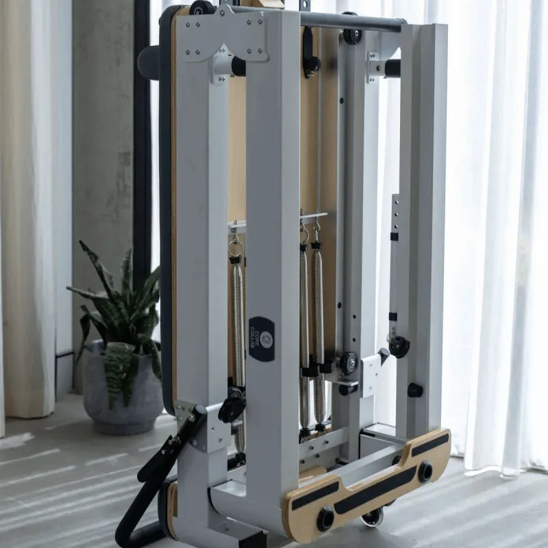 Close up image of the white frame queen foldable reformer in upright folded position