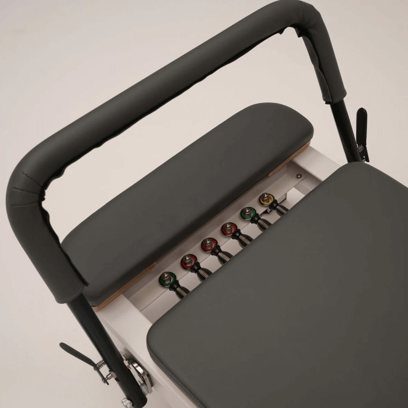 Aerial Close Up view of springs and footbar of Core Collab Queen Reformer with black upholstery