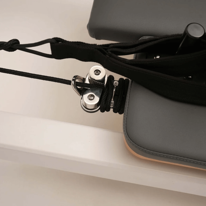 Extreme close up of hand straps looped over shoulder poles 