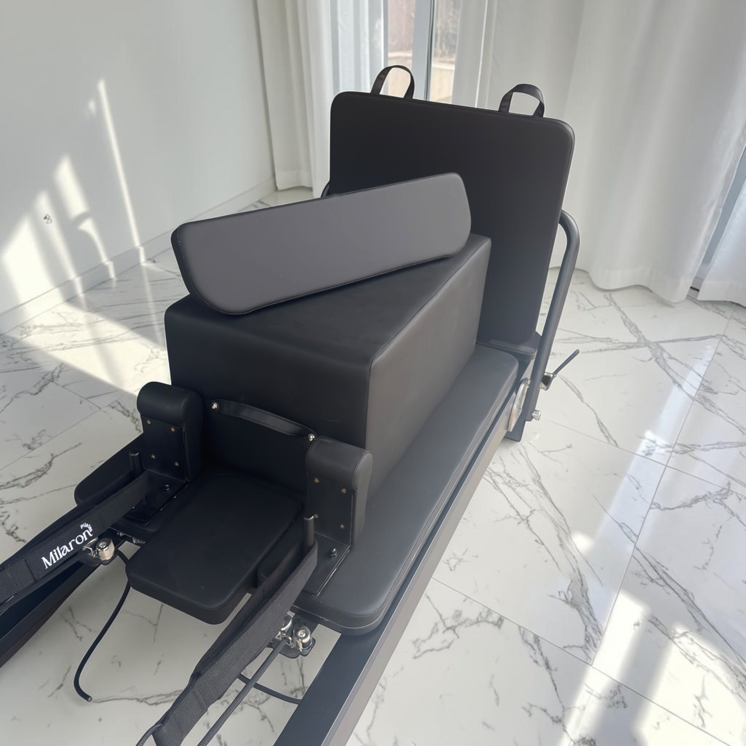 Side view of the Milaron Pearl V3 reformer in Noir showing the full carriage travel length and footbar