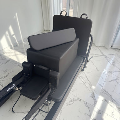 Side view of the Milaron Pearl V3 reformer in Noir showing the full carriage travel length and footbar