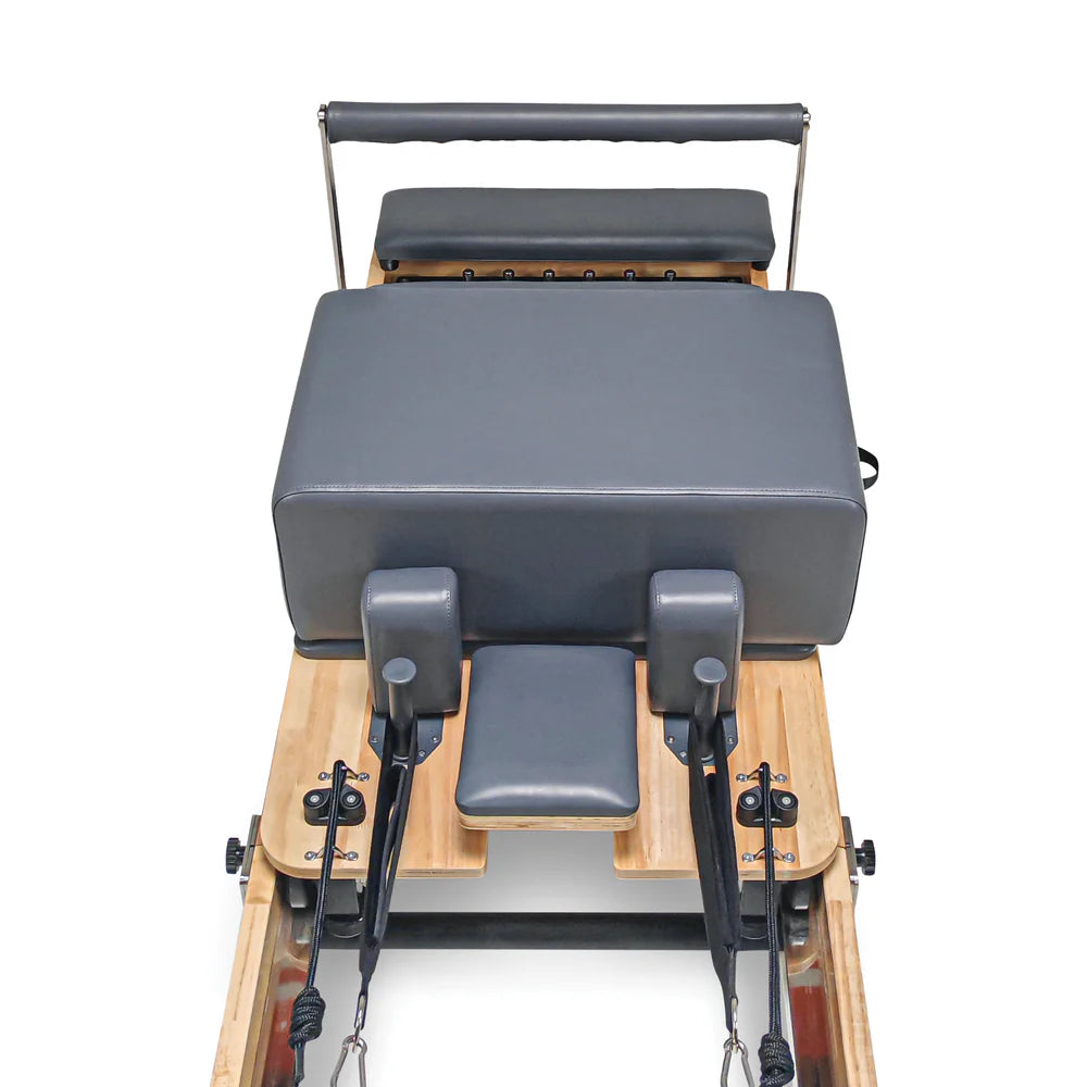 Aerial close up view of carriage, sitting box and footbar for Impact Fitness Foldable Pilates reformer in Dark Grey