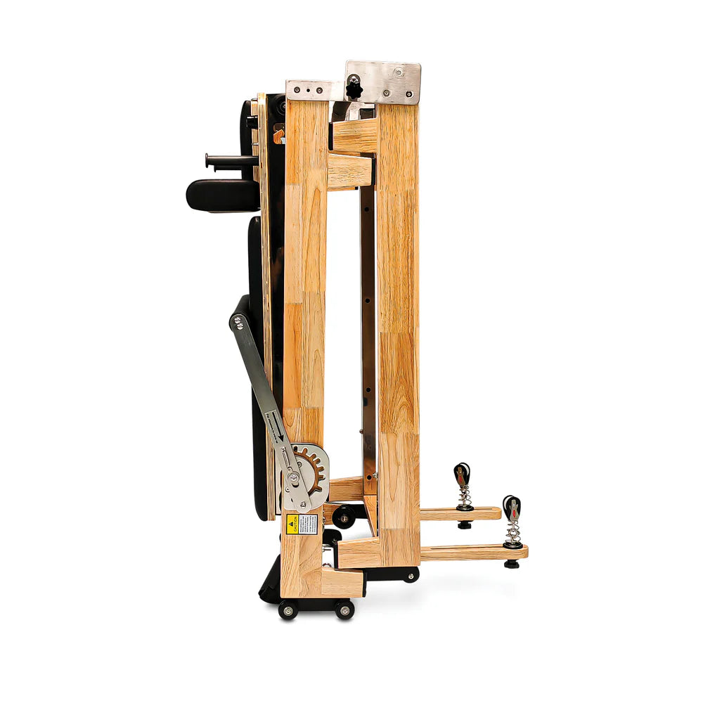 Folded Side standing view of Impact Fitness Foldable Pilates Reformer in black
