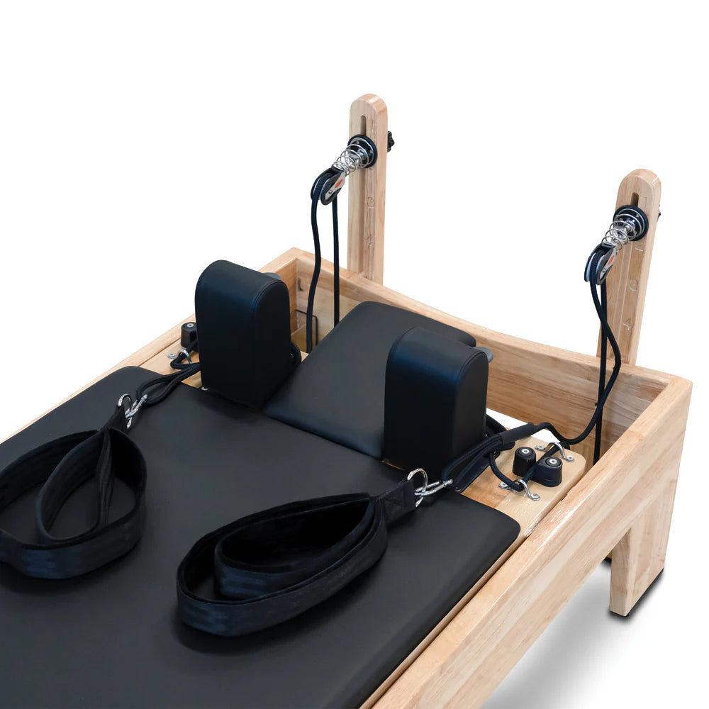Close up of the carriage, headrest and straps of the Impact Fitness Pilates Reformer machine