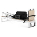 White pilates reformer with black leather on white background with sitting box and jumpboard attached