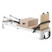 Side view of pilates reformer on white background with jumpboard up