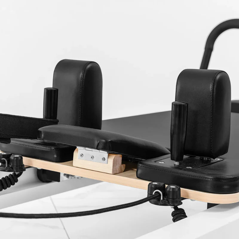 Close up of headrest on pilates reformer with black upholstery
