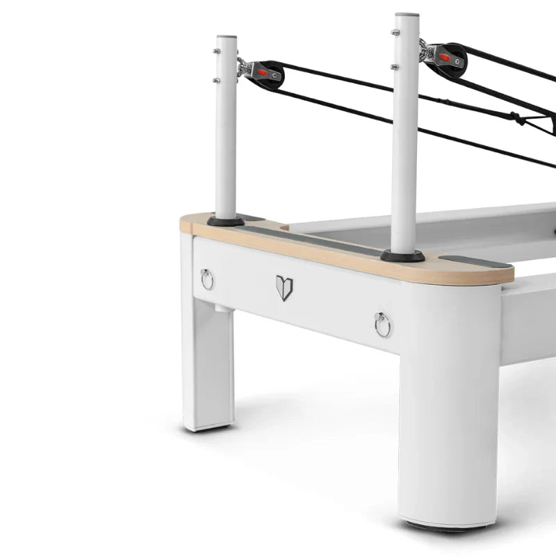 Close up on pulley riser poles on pilates reformer machine in white