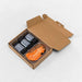 Aerial view of folded pilates reformer straps inside brown box