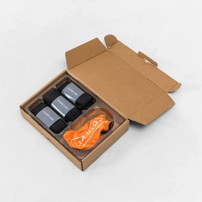 Aerial view of folded pilates reformer straps inside brown box
