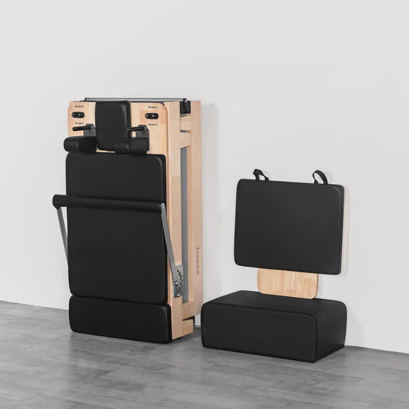Folded Lifespan Fitness Contour Pilates reformer machine with attachments on a gray floor against a white wall