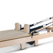Close up Beige Reformer Bed and Straps on white background