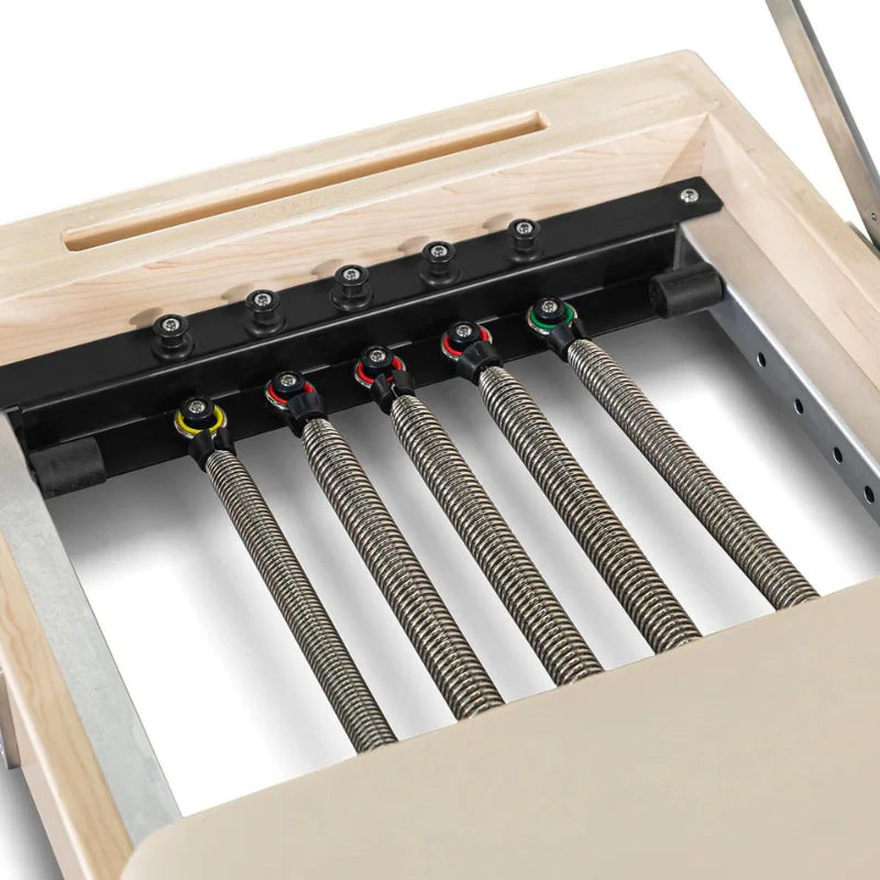 Close-up of a wooden frame with metal springs and adjustable components.