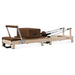 Side view Lifespan Fitness Contour Wooden Pilates Machine in Brown with footbar up on white background