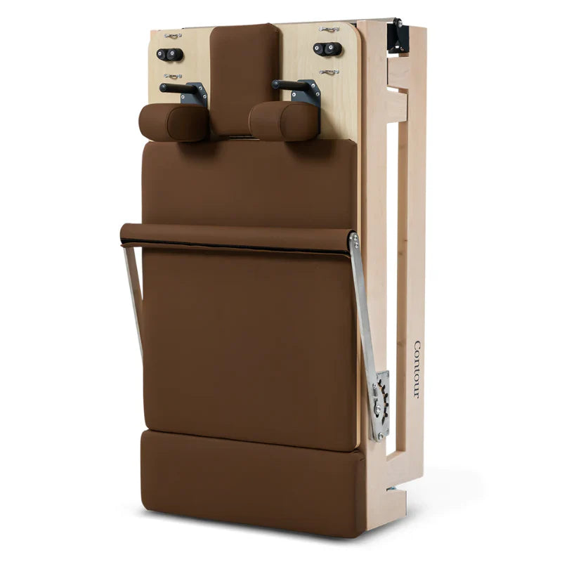 Folded wooden pilates reformer machine in brown on white background