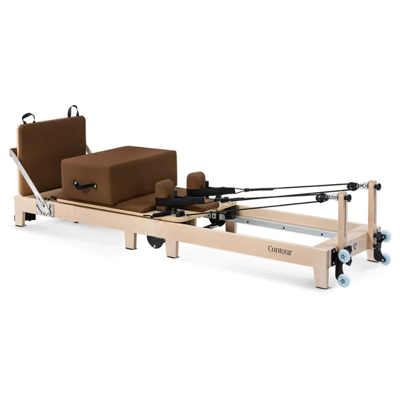 Full Side View of Wooden Pilates reformer in brown with accessories on white background