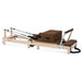 Side view Lifespan Fitness Contour Wooden Pilates Machine in brown on white background