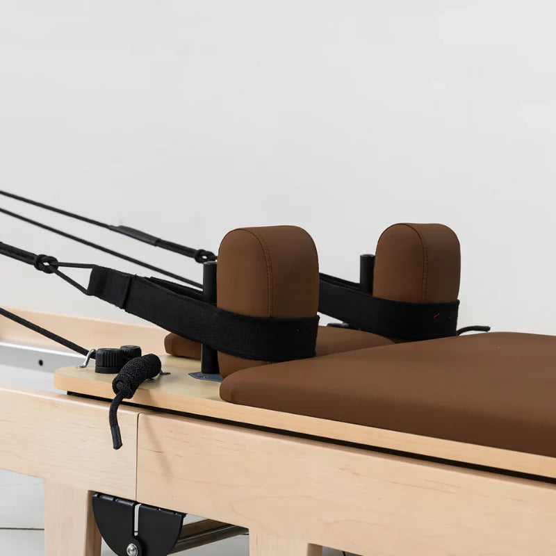 Close up carriage and straps on lifespan Fitness Wooden Pilates Reformer