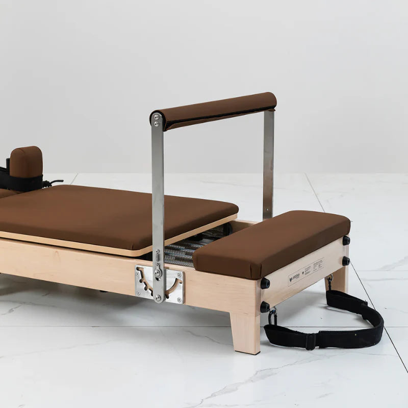 Lifespan Fitness Pilates Reformer in Brown with Footbar raised on white floor