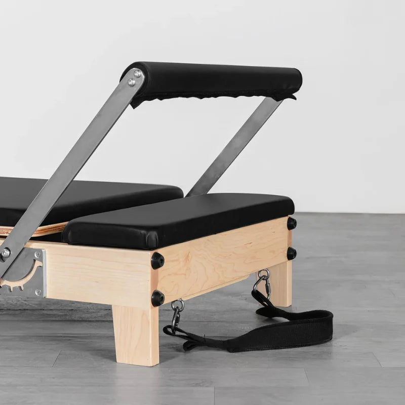 Close up raised footbar Lifespan Fitness Contour Folding Wooden Pilates Reformer in Black on WOoden floor