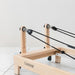 Close up wooden pulley riser for pilates reformer