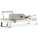 Full View from Footbar Angle of White Pilates Reformer Machine with sitting box on white background
