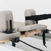Full Close up of shoulder pads and straps on pilates reformer machine with beige leather