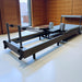 Full length angle view of pilates reformer bed in set up mode in studio setting