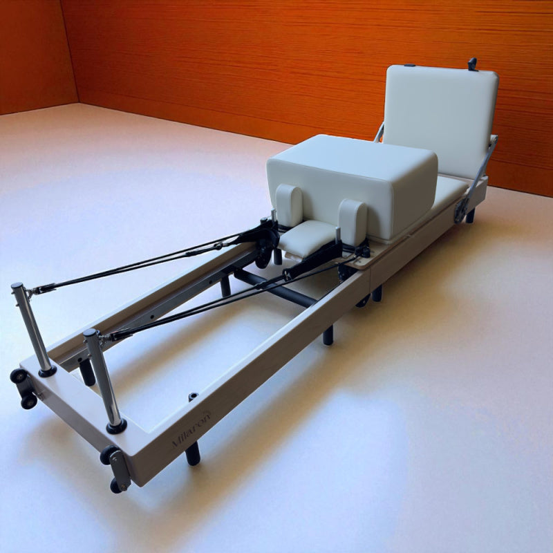 Studio setting image of Milaron Maple Foldable Reformer with jumpboard and sitting box