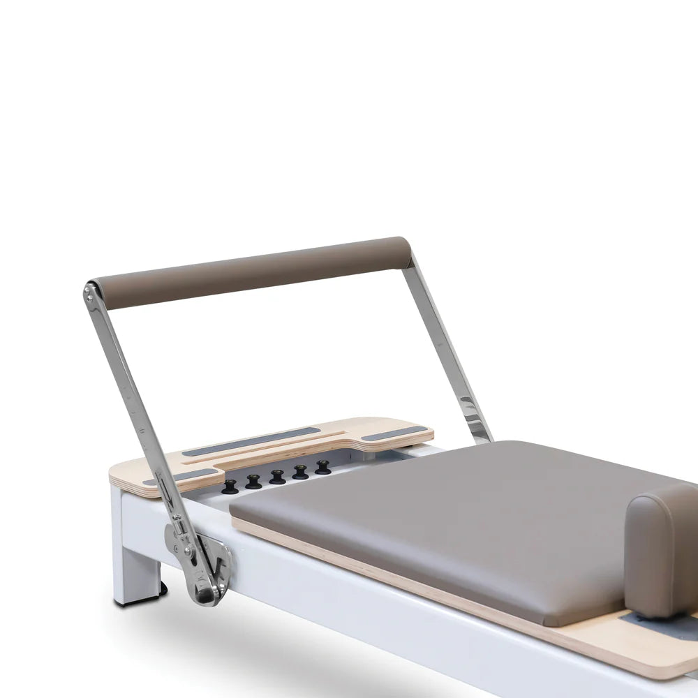 Angle Side View of Footbar of Reeplex Flow Series Studio Reformer in Brown with White Aluminium Frame