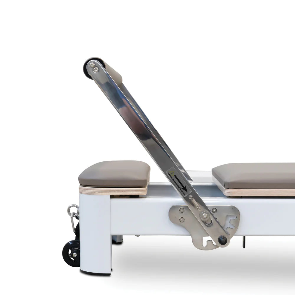 Close Up Side View of Reeplex Flow Series Studio Reformer with Footbar in Brown with White Aluminium Frame