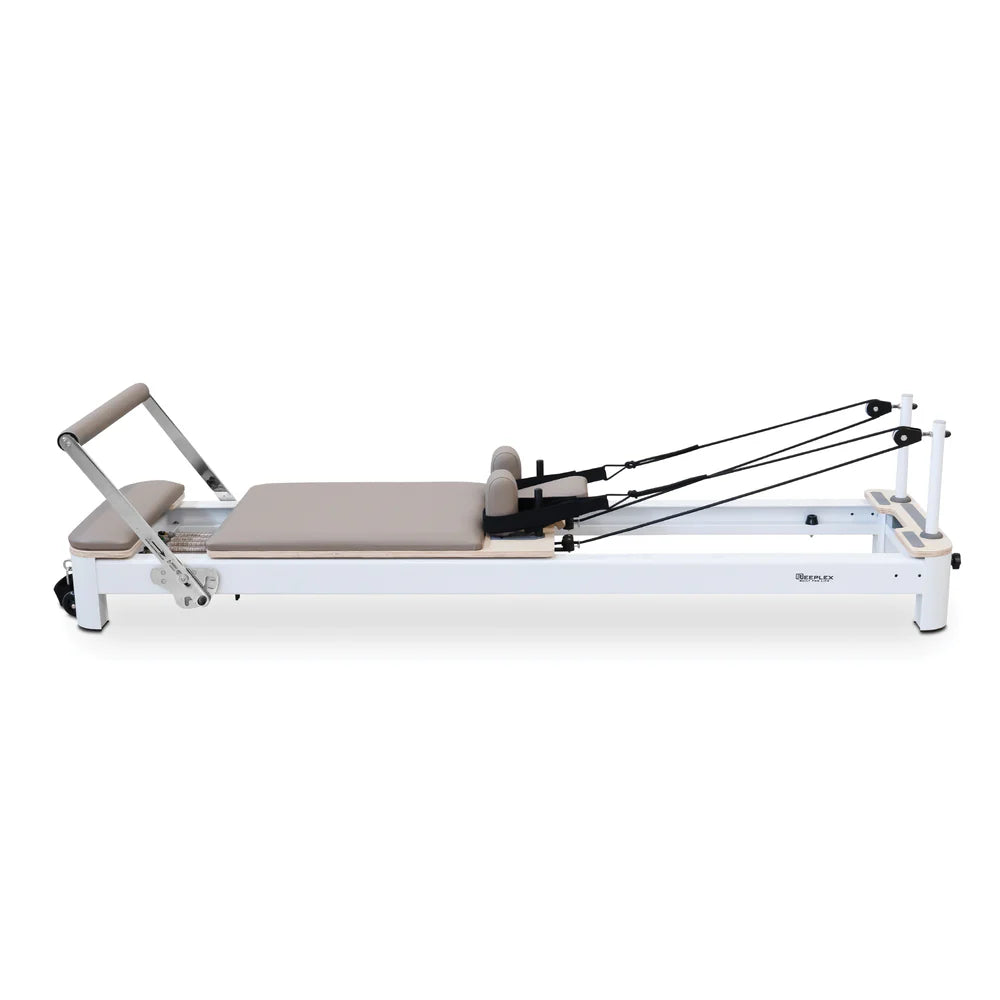 Side View of Reeplex Flow Series Studio Reformer with Footbar in Brown with White Aluminium Frame