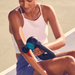 Image of female using the black Theragun Pro Plus massage gun on biceps