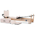 Angled Front View of Reeplex Luna Beechwood Studio Pilates Reformer in Pale Pink